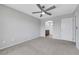 Primary bedroom leading to the bathroom with ceiling fan and neutral decor at 6678 Crystal Run Ln, Las Vegas, NV 89122