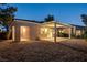 Backyard with patio cover, mature landscaping, and neutral toned stucco walls, perfect for entertaining at 713 Chase Tree St, Las Vegas, NV 89144
