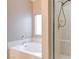 Bright bathroom showcasing a tub with white tile and a clear glass shower door at 713 Chase Tree St, Las Vegas, NV 89144