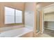 Bright bathroom features a soaking tub and separate glass-enclosed shower at 713 Chase Tree St, Las Vegas, NV 89144