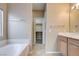 Bright bathroom features a soaking tub, and doorway to walk-in closet at 713 Chase Tree St, Las Vegas, NV 89144