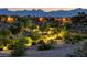 Scenic community view with walking paths, desert landscaping, and mountain views at twilight at 713 Chase Tree St, Las Vegas, NV 89144