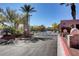 Secured community entrance gate surrounded by manicured landscaping and mature trees at 713 Chase Tree St, Las Vegas, NV 89144