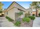Exterior view of a single-story home featuring low-maintenance desert landscaping with rocks and shrubs at 713 Chase Tree St, Las Vegas, NV 89144