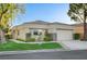 Charming single-story home with a two-car garage, well-manicured lawn and tidy landscaping at 713 Chase Tree St, Las Vegas, NV 89144