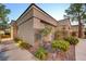Attractive single-story home featuring desert landscaping, mature trees, and a welcoming walkway at 713 Chase Tree St, Las Vegas, NV 89144