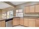 Bright kitchen offers stainless steel dishwasher, tile floors, and granite countertops at 713 Chase Tree St, Las Vegas, NV 89144