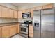 Well-lit kitchen features stainless steel appliances and light wood cabinets at 713 Chase Tree St, Las Vegas, NV 89144