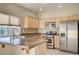 Well-equipped kitchen featuring stainless steel appliances, granite countertops, and ample cabinet space at 713 Chase Tree St, Las Vegas, NV 89144