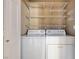 Well-organized laundry room with washer, dryer, and wire shelving for storage at 713 Chase Tree St, Las Vegas, NV 89144