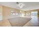 Bright living room with tile flooring, multiple windows, and a ceiling fan for added comfort at 713 Chase Tree St, Las Vegas, NV 89144