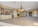 Spacious open-concept living area featuring tile floors, an elegant light fixture, and a cozy fireplace at 713 Chase Tree St, Las Vegas, NV 89144