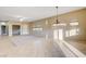 Open-concept living room featuring neutral tile, a ceiling fan, and ample sunlight at 713 Chase Tree St, Las Vegas, NV 89144