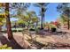 Charming seating area near the community pool, showcasing lush landscaping and mature trees at 713 Chase Tree St, Las Vegas, NV 89144
