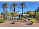 Scenic pool area with palm trees, lounge chairs, and well-maintained landscaping, perfect for relaxation at 713 Chase Tree St, Las Vegas, NV 89144