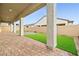 Covered patio with pavers, artificial turf, and privacy wall, perfect for outdoor living at 717 Monroe Hill Pl, Henderson, NV 89011