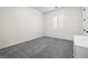 Comfortable bedroom features soft gray carpet, a white cabinet and a window with plantation shutters at 717 Monroe Hill Pl, Henderson, NV 89011