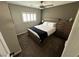 Cozy bedroom with a queen-sized bed, wood furnishings, and natural light filtering through plantation shutters at 7226 Freedom Ring St, Las Vegas, NV 89148