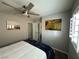 Bright bedroom with a queen bed, modern ceiling fan, and plantation shutters for ample natural light at 7226 Freedom Ring St, Las Vegas, NV 89148