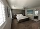 Serene bedroom featuring a comfortable bed, neutral tones, and natural light from shuttered windows at 7226 Freedom Ring St, Las Vegas, NV 89148
