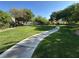 A serene community park with lush green space, meandering walking path, and meticulously maintained landscaping at 7226 Freedom Ring St, Las Vegas, NV 89148