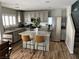 Well-equipped kitchen featuring stainless steel appliances, a granite island, and shaker cabinets at 7226 Freedom Ring St, Las Vegas, NV 89148