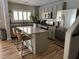 Modern kitchen with stainless steel appliances, granite countertops and a breakfast bar at 7226 Freedom Ring St, Las Vegas, NV 89148
