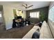 Comfortable living area with a sofa, desk, and ample natural light, perfect for relaxing or working at 7226 Freedom Ring St, Las Vegas, NV 89148
