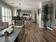Inviting living space showcasing wood-style floors and seamless flow into the kitchen and dining areas at 7226 Freedom Ring St, Las Vegas, NV 89148