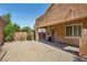 The backyard features gravel landscaping, with a covered patio area extending the living space outdoors for relaxation and enjoyment at 7407 Bakewell Ave, Las Vegas, NV 89179