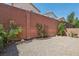 The backyard features gravel landscaping, plants, and a brick-lined square adding charm to the outdoor space at 7407 Bakewell Ave, Las Vegas, NV 89179