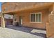 The backyard features gravel landscaping, with a covered patio area extending the living space outdoors for relaxation and enjoyment at 7407 Bakewell Ave, Las Vegas, NV 89179