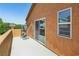 This balcony features an open patio, with sliding glass door, and workout equipment, offering an outdoor space at 7407 Bakewell Ave, Las Vegas, NV 89179