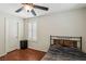 Bedroom featuring hardwood floors, shutters, ceiling fan, and dark furniture at 7407 Bakewell Ave, Las Vegas, NV 89179