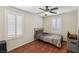 Cozy bedroom with hardwood floors, plantation shutters, and a ceiling fan at 7407 Bakewell Ave, Las Vegas, NV 89179
