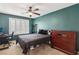 Stylish bedroom with a dark teal accent wall, plantation shutters, and a ceiling fan at 7407 Bakewell Ave, Las Vegas, NV 89179