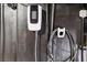 Image features a wall-mounted electric vehicle charger, showcasing modern convenience for eco-friendly homeowners at 7407 Bakewell Ave, Las Vegas, NV 89179