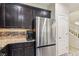 Well-appointed kitchen boasting stainless steel appliances, dark wood cabinetry, and a modern refrigerator at 7407 Bakewell Ave, Las Vegas, NV 89179