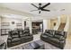 Open-concept living room with a modern ceiling fan, neutral walls, and seamless flow to the kitchen at 7407 Bakewell Ave, Las Vegas, NV 89179