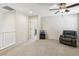 Upstairs loft area featuring neutral carpet, a ceiling fan, and natural light at 7407 Bakewell Ave, Las Vegas, NV 89179