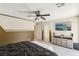 Spacious carpeted main bedroom featuring a ceiling fan, recessed lighting, and a tv at 7407 Bakewell Ave, Las Vegas, NV 89179