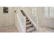 View of the carpeted staircase with white railing, ascending to the upper level of the home at 7407 Bakewell Ave, Las Vegas, NV 89179