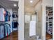 Bathroom featuring a glass shower next to closets with hanging and shelving at 7445 Mezzanine View Ave, Las Vegas, NV 89178