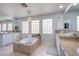 Bright bathroom with large soaking tub, glass block windows, dual vanities and tan tile at 7445 Mezzanine View Ave, Las Vegas, NV 89178