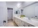 Bright bathroom featuring a long vanity with dual sinks and white cabinets at 7445 Mezzanine View Ave, Las Vegas, NV 89178