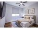 Cozy bedroom with a ceiling fan, a plush bed, and warm, inviting decor at 7445 Mezzanine View Ave, Las Vegas, NV 89178