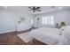 Bright bedroom featuring wood floors, ceiling fan, plantation shutters, and a neutral color palette at 7445 Mezzanine View Ave, Las Vegas, NV 89178