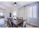 A dining area with a wooden table and seating for six at 7445 Mezzanine View Ave, Las Vegas, NV 89178