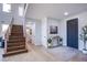 Bright foyer with hardwood floors, a wooden staircase and neutral decor at 7445 Mezzanine View Ave, Las Vegas, NV 89178