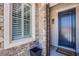 Close up of the home's entry door with stone and a Welcome mat at 7445 Mezzanine View Ave, Las Vegas, NV 89178